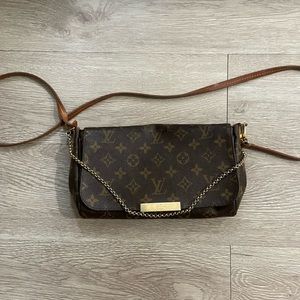 Louis Vuitton clutch with shoulder strap.